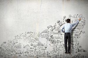 Back view of businessman drawing sketch on wall